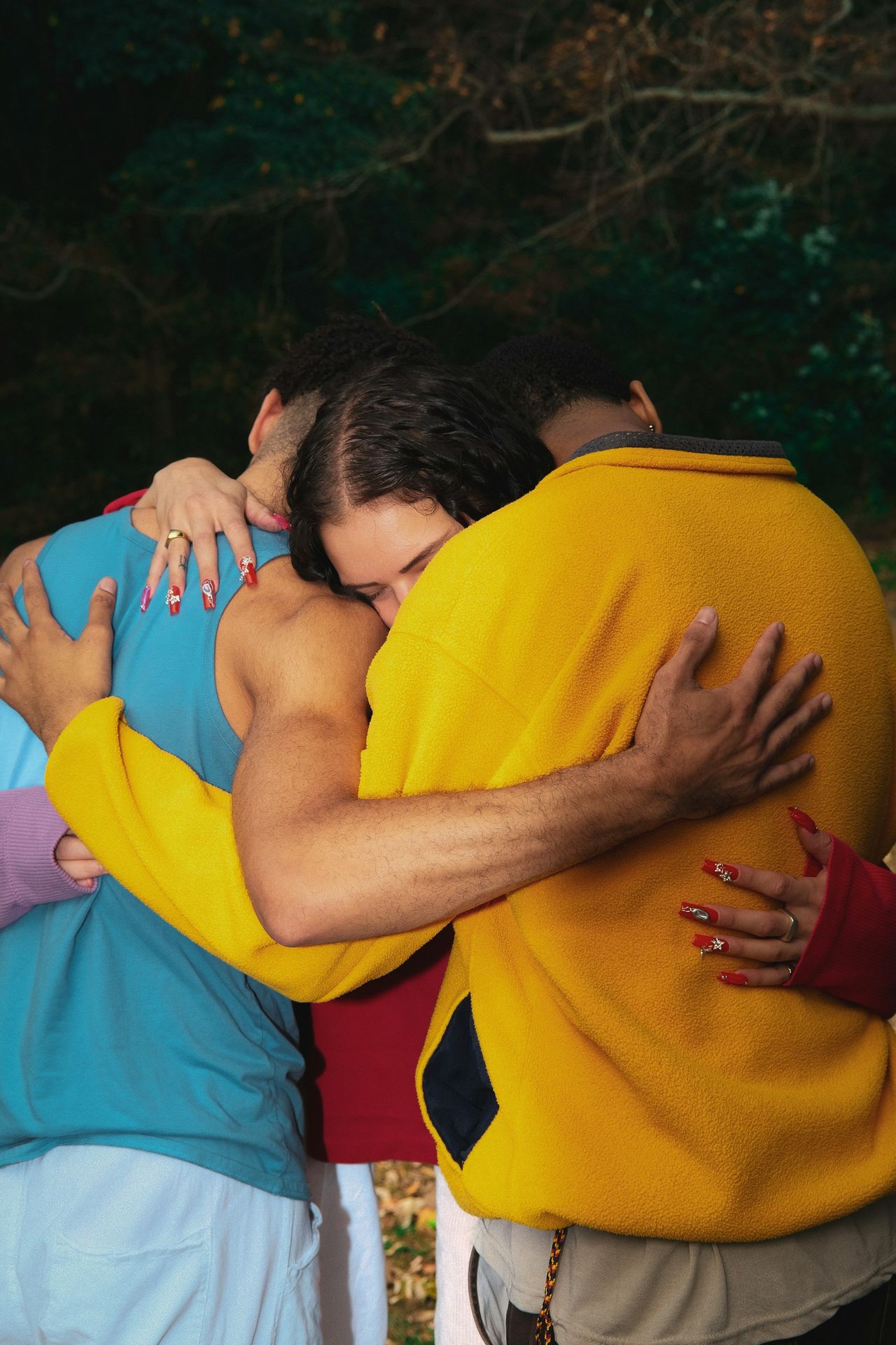 A group of people hugging each other outside